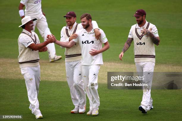 Gus Atkinson of Surrey celebrates with team mates after taking the wicket of Luke Procter of Northamptonshire during the LV= Insurance County...