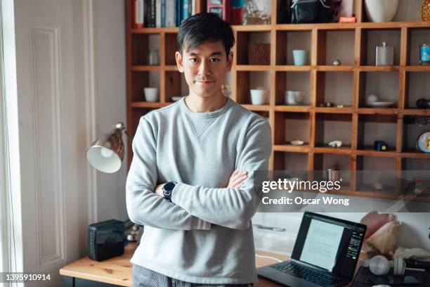 portrait of confident young asian man looking at camera  at home office - small office stock pictures, royalty-free photos & images