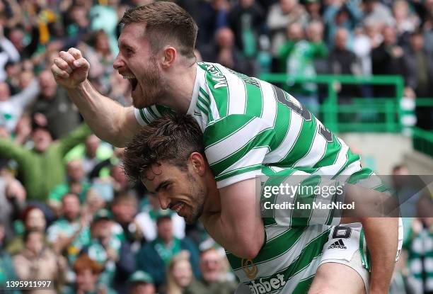 Matt O'Riley of Celtic is congratulated by teammates Anthony Ralston and Liel Abada after scoring their team's third goal during the Cinch Scottish...