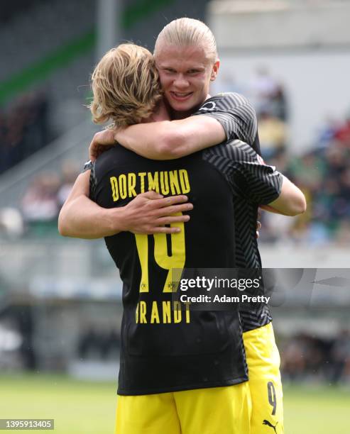 Julian Brandt celebrates with Erling Haaland of Borussia Dortmund after scoring their team's first goal during the Bundesliga match between SpVgg...