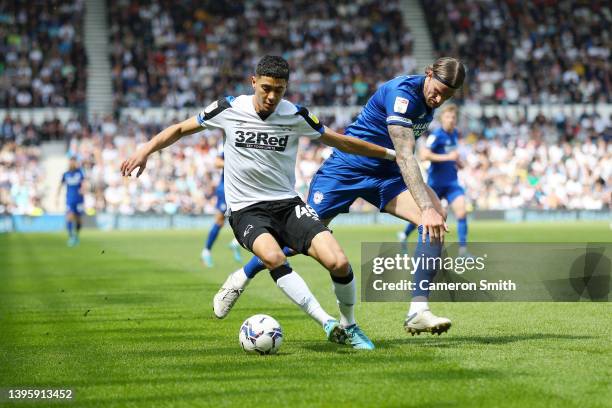 Luke Plange of Derby County is challenged by Aden Flint of Cardiff City during the Sky Bet Championship match between Derby County and Cardiff City...