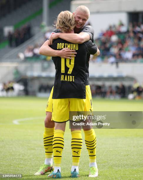 Julian Brandt celebrates with Erling Haaland of Borussia Dortmund after scoring their team's first goal during the Bundesliga match between SpVgg...