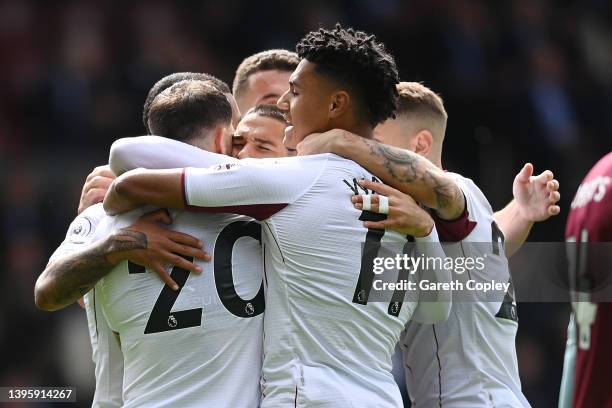 Danny Ings of Aston Villa is congratulated by Emiliano Buendia, Ollie Watkins and teammates after scoring their team's first goal during the Premier...