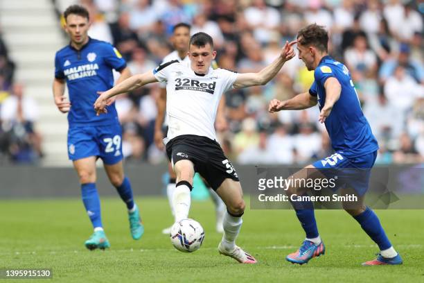 Jason Knight of Derby County is challenged by Ryan Wintle of Cardiff City during the Sky Bet Championship match between Derby County and Cardiff City...