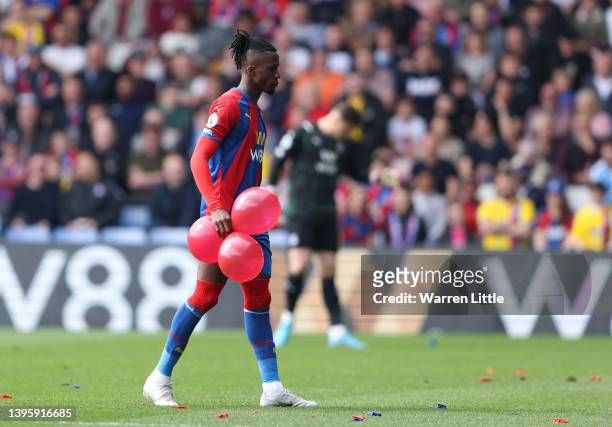 Wilfried Zaha of Crystal Palace carries balloons off the pitch during the Premier League match between Crystal Palace and Watford at Selhurst Park on...