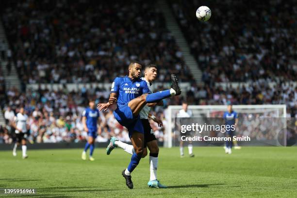 Curtis Nelson of Cardiff City is challenged by Luke Plange of Derby County during the Sky Bet Championship match between Derby County and Cardiff...