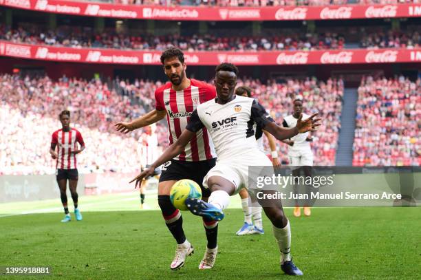 Mouctar Diakhaby of Valencia CF duels for the ball with Raul Garcia of Athletic Club during the La Liga Santander match between Athletic Club and...