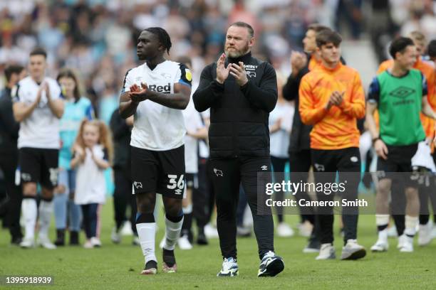 Wayne Rooney, Manager of Derby County and Festy Ebosele of Derby County applauds fans after the Sky Bet Championship match between Derby County and...