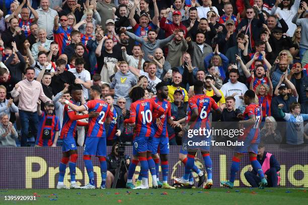 Wilfried Zaha of Crystal Palace celebrates with teammates after scoring their team's first goal during the Premier League match between Crystal...