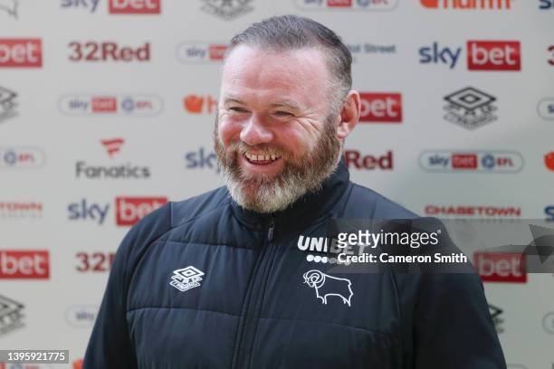 Wayne Rooney, Manager of Derby County smiles in a media interview after the Sky Bet Championship match between Derby County and Cardiff City at Pride...