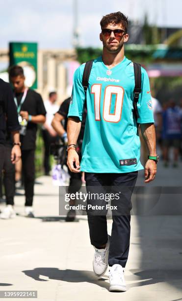 Pierre Gasly of France and Scuderia AlphaTauri wears a Miami Dolphins shirt as he walks in the Paddock prior to final practice ahead of the F1 Grand...