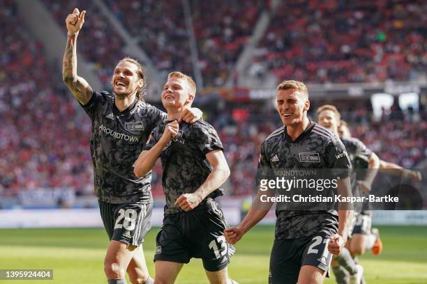 Andras Schafer of 1.FC Union Berlin celebrates with teammates Christopher Trimmel and Grischa Proemel after scoring their team's fourth goal during...