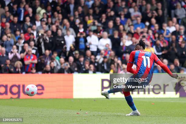 Wilfried Zaha of Crystal Palace scores their team's first goal from the penalty spot during the Premier League match between Crystal Palace and...