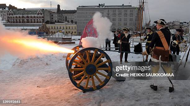 Members of a Historical re-enactment group dressed as the Finnish Regiment "Nylands Infanteri Regemente" of the Swedish army, fire a cannon to salute...