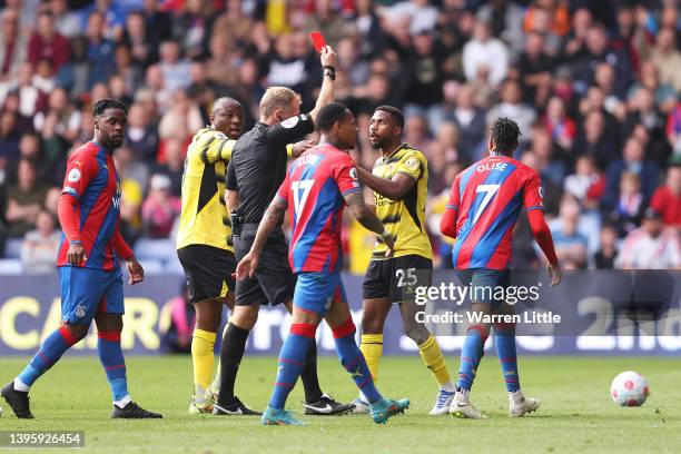 Emmanuel Dennis reacts as referee Graham Scott shows a red card to Hassane Kamara of Watford FC during the Premier League match between Crystal...