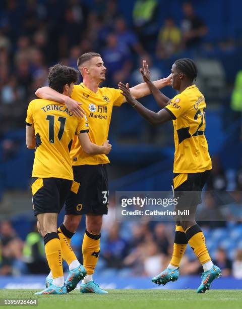 Francisco Trincao celebrates with Leander Dendoncker and Chiquinho of Wolverhampton Wanderers after scoring their team's first goal during the...