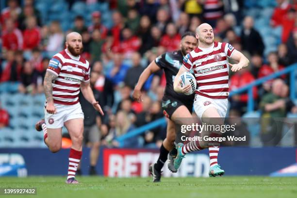 Liam Marshall of Wigan Warriors makes a break before scoring their side's fourth try during the Betfred Challenge Cup Semi Final match between Wigan...