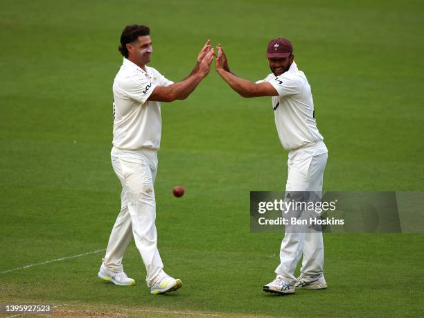 Colin de Grandhomme of Surrey celebrates with team mate Ryan Patel after taking the wicket of Tom Taylor of Northamptonshire during the LV= Insurance...