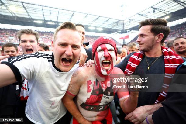 Koeln fans celebrate after their sides qualification for European football during the Bundesliga match between 1. FC Köln and VfL Wolfsburg at...