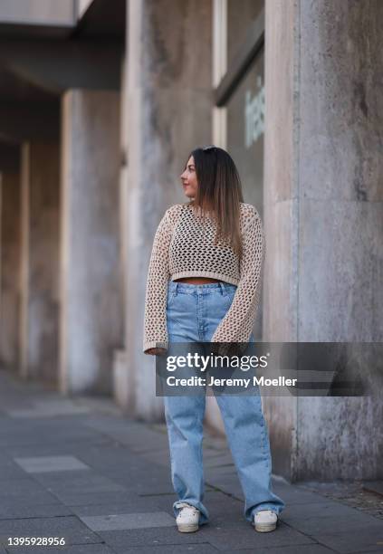 Linda Ehrmann seen wearing a beige crochet sweater from C Noir, a blue denim wide leg jeans from Zara and creme sneakers from Manebi on May 01, 2022...