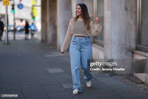 Linda Ehrmann seen wearing a beige crochet sweater from C Noir, a blue denim wide leg jeans from Zara and creme sneakers from Manebi on May 01, 2022...