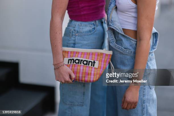 Johanna Löer seen wearing a pink fluffy tank top, a blue denim jeans, a colorful bag from Isabel Marant and Henni seen wearing a white crochet logo...