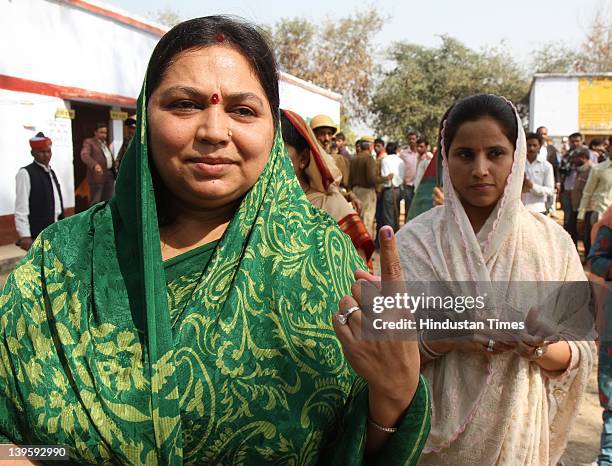 Samajwadi party Chief Mulayam Singh Yadav's wife Sadhana Yadav shows her ink marked finger after casting her vote at Safai Junior High School during...