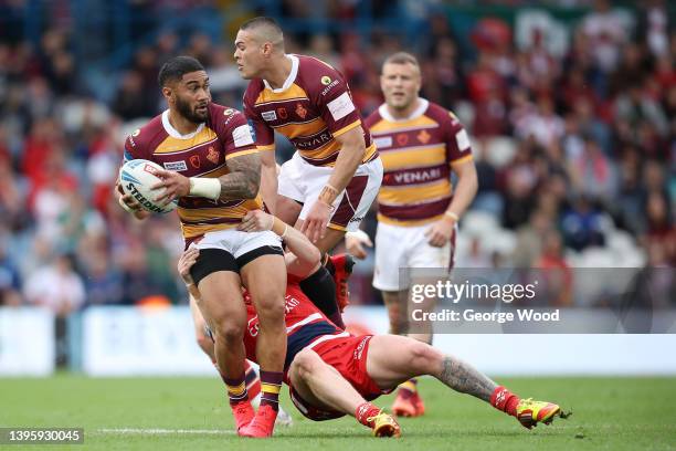 Ricky Leutele of Huddersfield Giants is tackled by Ethan Ryan of Hull Kingston Rovers during the Betfred Challenge Cup Semi Final match between...