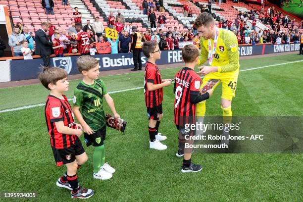 Golden Glove winner Mark Travers of Bournemouth comes out for a traditional walk around the pitch after his sides 1-0 win to sign autographs for...