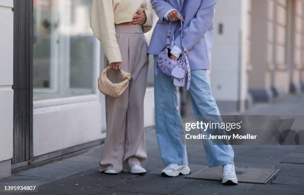 Michi Brandl seen wearing a pale yellow cropped pullover from Vival Studio, a gold necklace and gold earrings, a beige wide leg pants from Reserved,...