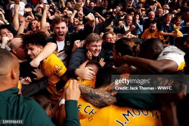 Conor Coady of Wolverhampton Wanderers celebrates after scoring his team's second goal with teammates and fans during the Premier League match...