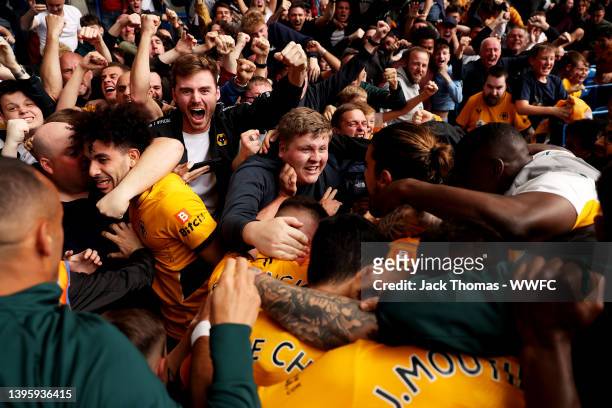 Conor Coady of Wolverhampton Wanderers celebrates after scoring his team's second goal with teammates and fans during the Premier League match...