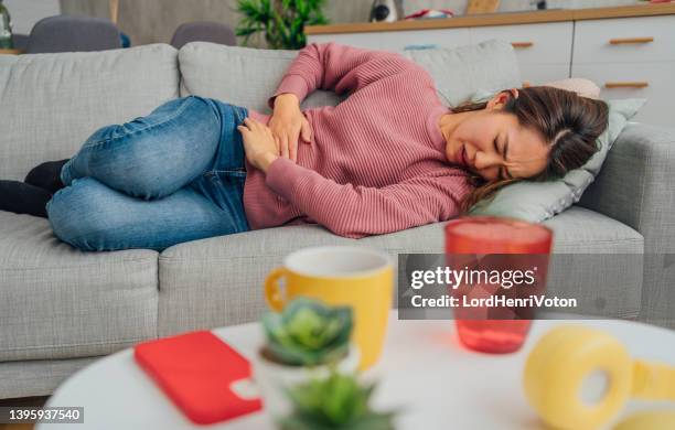 these cramps are ruining my whole day - food borne illness stock pictures, royalty-free photos & images