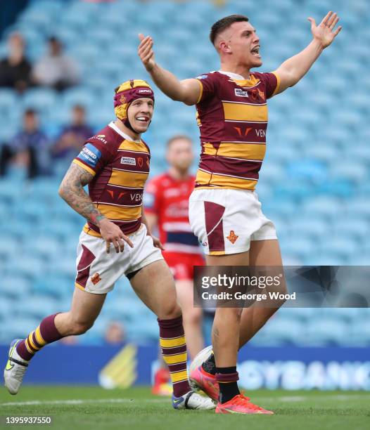 Owen Trout of Huddersfield Giants celebrates with teammate Theo Fages after scoring their side's fourth try during the Betfred Challenge Cup Semi...