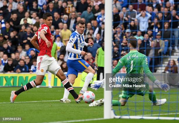 Pascal Gross of Brighton & Hove Albion scores their team's third goal past David De Gea of Manchester United during the Premier League match between...