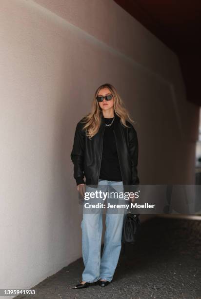 Isabelle Hartmann seen wearing a black sunglasses from Saint Laurent, a silver Tiffany & Co Hardwear necklace, a black shirt from The Frankie Shop, a...