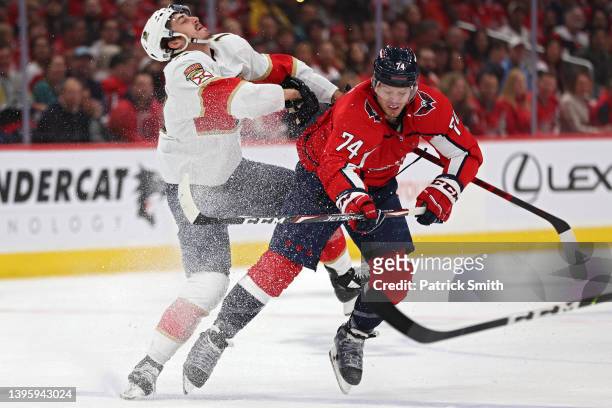 John Carlson of the Washington Capitals checks Mason Marchment of the Florida Panthers during the first period in Game Three of the First Round of...