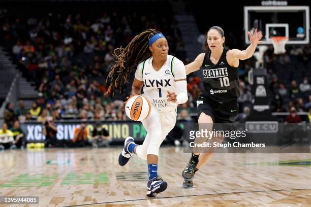 Odyssey Sims of the Minnesota Lynx dribbles against Sue Bird of the Seattle Storm during the first half at Climate Pledge Arena on May 06, 2022 in...