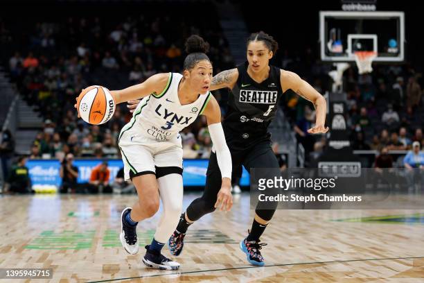 Aerial Powers of the Minnesota Lynx dribbles against Gabby Williams of the Seattle Storm during the first half at Climate Pledge Arena on May 06,...