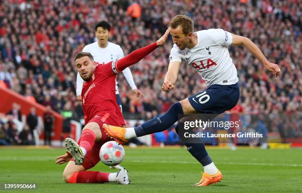 Harry Kane of Tottenham Hotspur shoots under pressure from Jordan Henderson of Liverpool during the Premier League match between Liverpool and...