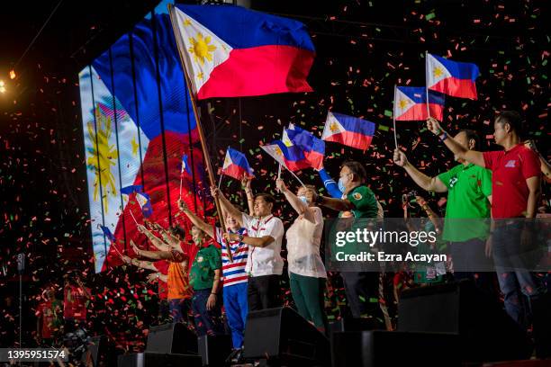 Ferdinand "Bongbong" Marcos Jr. And running mate Sara Duterte wave Philippine flags during their last campaign rally before the election on May 07,...