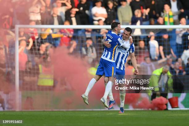 Pascal Gross and Lewis Dunk of Brighton & Hove Albion celebrate at the end of the Premier League match between Brighton & Hove Albion and Manchester...