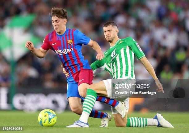 Gavi of FC Barcelona is challenged by Guido Rodriguez of Real Betis during the La Liga Santander match between Real Betis and FC Barcelona at Estadio...