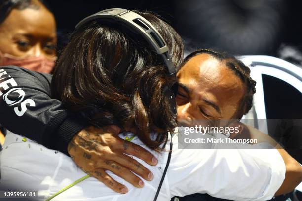 Lewis Hamilton of Great Britain and Mercedes hugs Michelle Obama in his garage during final practice ahead of the F1 Grand Prix of Miami at the Miami...