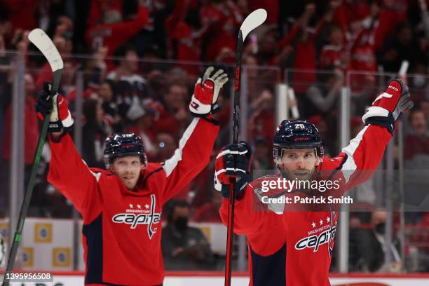 Nic Dowd and Lars Eller of the Washington Capitals celebrate a goal by teammate John Carlson of the Washington Capitals against the Florida Panthers...