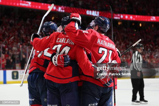John Carlson of the Washington Capitals celebrates his empty net goal with teammates against the Florida Panthers during the third period in Game...