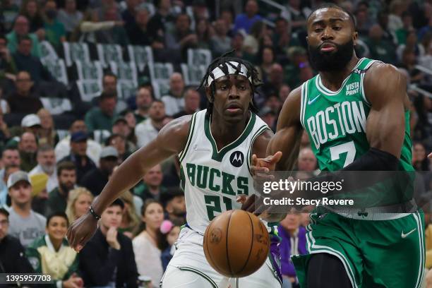 Jrue Holiday of the Milwaukee Bucks strips the ball from Jaylen Brown of the Boston Celtics during the first quarter of Game Three of the Eastern...