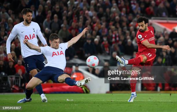 Mohamed Salah of Liverpool shoots under pressure from Ben Davies of Tottenham Hotspur during the Premier League match between Liverpool and Tottenham...