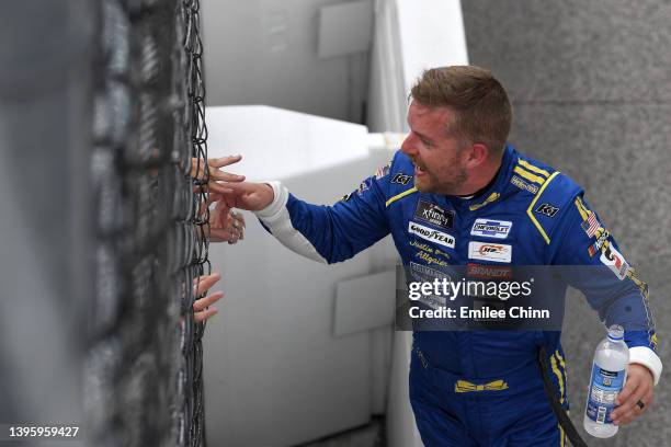 Justin Allgaier, driver of the Hellmann's Chevrolet, celebrates with fans through the fence after winning the NASCAR Xfinity Series Mahindra ROXOR...