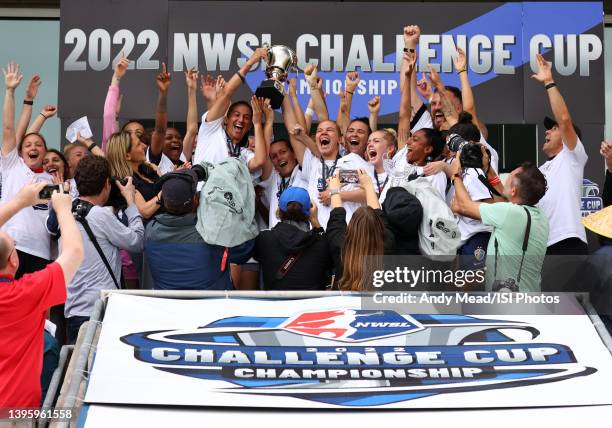 Captain Abby Erceg and teammate Merritt Mathias of the North Carolina Courage lift the championship trophy overhead in celebration after a game...